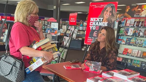 Brittany Wagners talking with fan at book signing